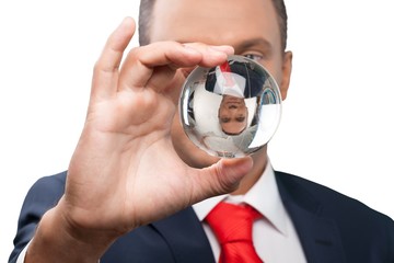 Close-up of young business man holding glass globe