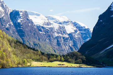 Shore with small houses among the mountains in summer