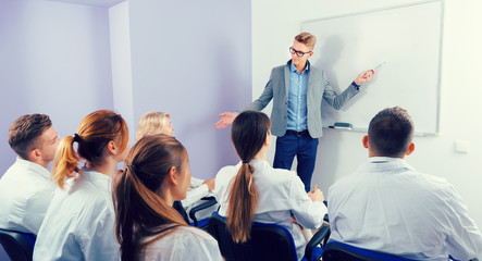 Fototapeta na wymiar Confident male student answering near whiteboard