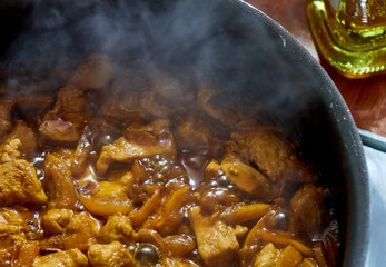 Turkey stew in the tomato sauce inside a frying pan, beign cooked