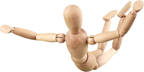 Wooden mannequin in a skydiving pose