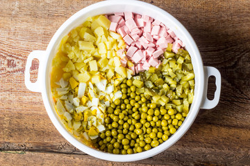 Russian traditional salad Olivier with vegetables and meat. Winter salad