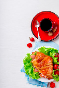 Fresh Croissant Sandwich with  Ham, Cheese,Cherry tomatoes and Salad leaf  on the Tray with Coffee   Breakfast in bed Delicious Baking  Light Meal