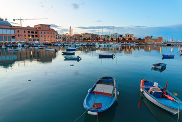 Evening view of marina with different boats. Old Town district. Bari, Italy.