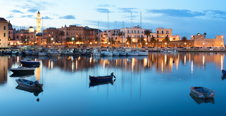 Evening view of marina with different boats. Old Town district. Bari, Italy.