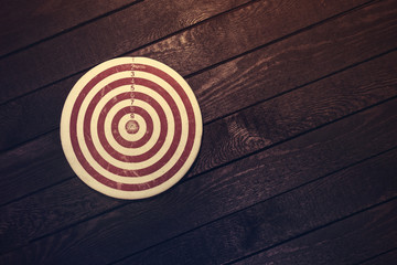 Dart board on dark wooden table