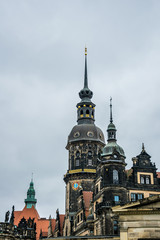 Fototapeta na wymiar Spire of the clock tower at the royal palace in Dresden and the gloomy sky, Germany