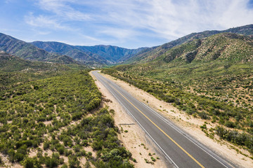 Fototapeta na wymiar Asphalt highway leads deep into the mountains of southern California.
