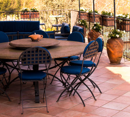 Cozy forged furniture on the balcony or terrace overlooking the garden. Place for rest