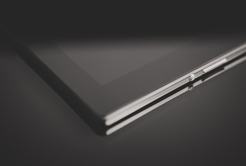 Black tablet pc on mirrored surface. Space for your text.