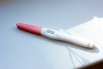 Negative pregnancy test on white table.