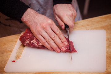 Cutting raw meat