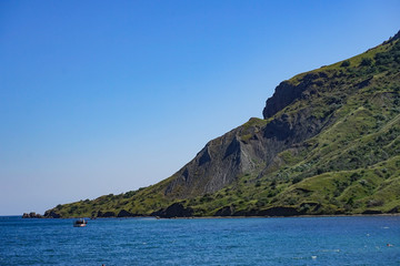 Obraz premium Seascape with a view of the coastline and the calm blue sea.