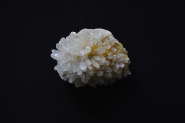 White Crystal Mineral, a Druse on a black background