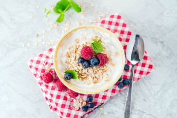 Yogurt with blueberry, raspberry and oatmeal flakes