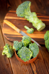 Fresh organic broccoli, cutted on kitchen board.