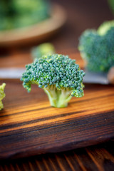 Fresh broccoli florets staying on the kitchen board like a tree.