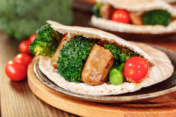 Meat with vegetables in a pita bread.