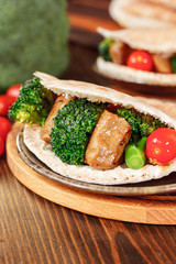 Vegetarian seitan with vegetables inside pita bread.