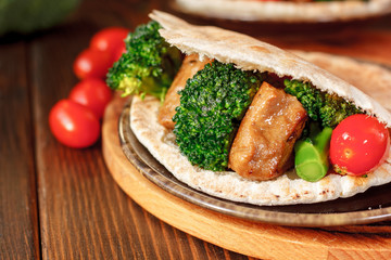 Vegetarian seitan with vegetables inside pita bread.