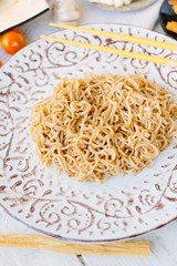 Chinese food: rice noodles on ceramic plate.
