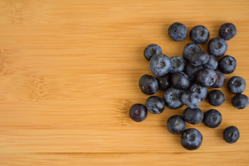 Fresh blueberries on wooden background closeup