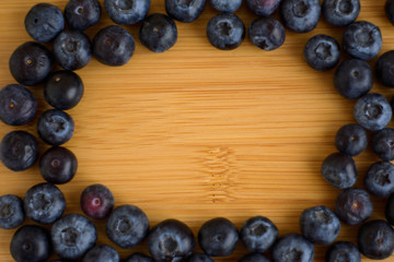 Fresh blueberries on wooden background closeup