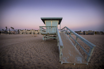 A beautiful sunset sky over a lifeguard shack in Hermosa Beach, California.