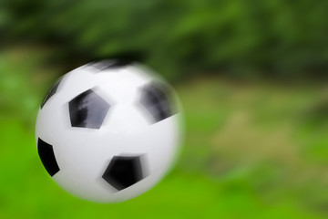 Soccer ball on a green background, soft focus