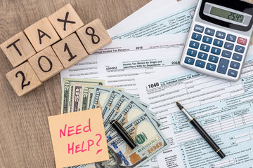 Time to pay taxes, 1040  form with wooden bricks