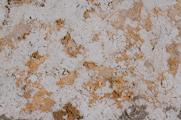The texture of a natural gray stone with golden impregnations. Copy space stone background.