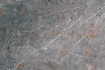The texture of a natural gray stone with golden impregnations. Copy space stone background.