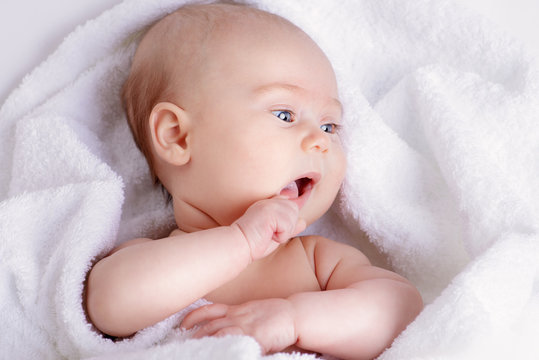 newborn in white towel