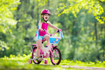 Child riding bike. Kid on bicycle.