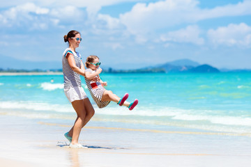 Mother and child on tropical beach. Sea vacation