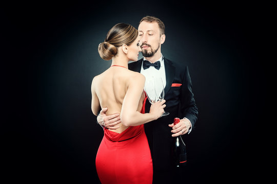 Elegant couple in evening dress embracing each other in love celebrating on classy party