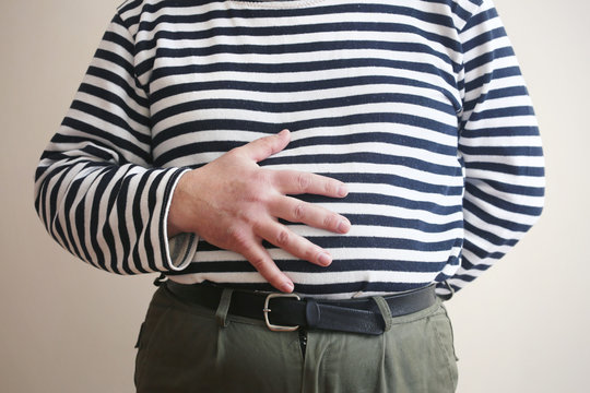 Man with hand on belly