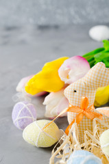Easter composition with bunny, eggs and tulips.