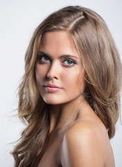 Fototapeta premium Portrait of young happy smiling thinking woman, over grey backgr