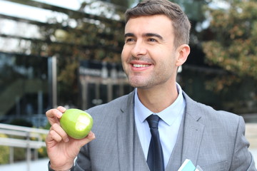 Healthy entrepreneur eating an apple on the go