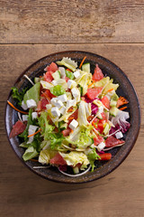 Grapefruit, tomato, lettuce and cucumber salad with feta cheese. Clean eating, healthy and diet food concept. View from above, top