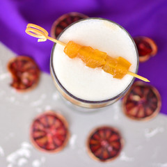 Crystal glass of a hot coffee cocktail with a slices of melon.