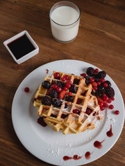 Belgian waffles with fruits and milk