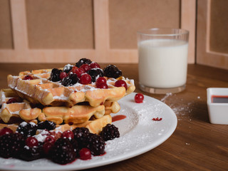 Belgian waffles with fruits and milk