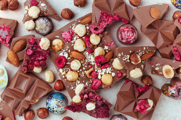 Background of broken bars of milk chocolate and chocolate candies