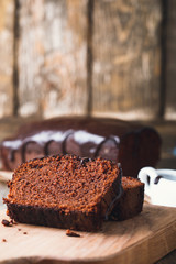 Slices of chocolate cake on wooden cutting board