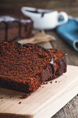 Slices of chocolate cake on wooden cutting board