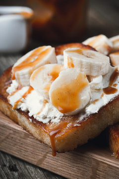 Breakfast  toasts with cream cheese, bananas and caramel sauce