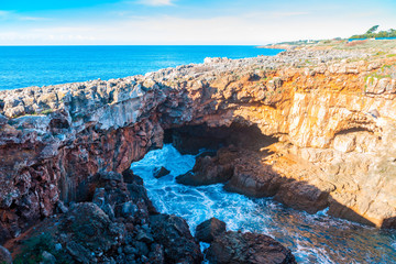 Devils Mouth, Boca do Inferno is a natural phenomenon occurring at the point where a rock formation meets the Atlantic waves in Cascais, Portugal. - obrazy, fototapety, plakaty