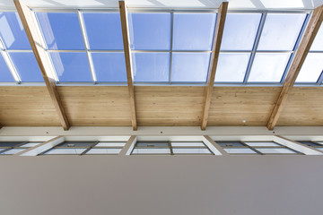 looking up at skylights and wooden design in a building